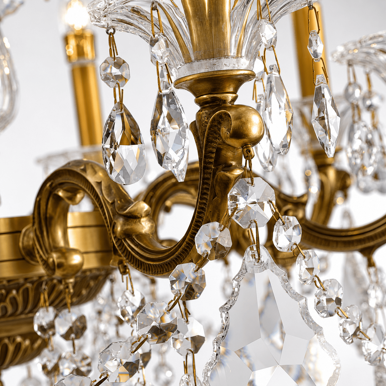 Close-up detail of the Imperial Grace Éclat chandelier, showing bronze-plated armwork and hand cut Asfour crystal drops.