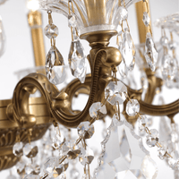 Close-up detail of the Imperial Grace Éclat chandelier, showing bronze-plated armwork and hand cut Asfour crystal drops.