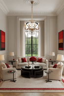 Petite chandelier hanging in an elegant sitting room with tall windows and red accents.