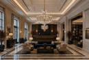 Luxury private members club reception with grand crystal chandeliers and burgundy architectural plants.