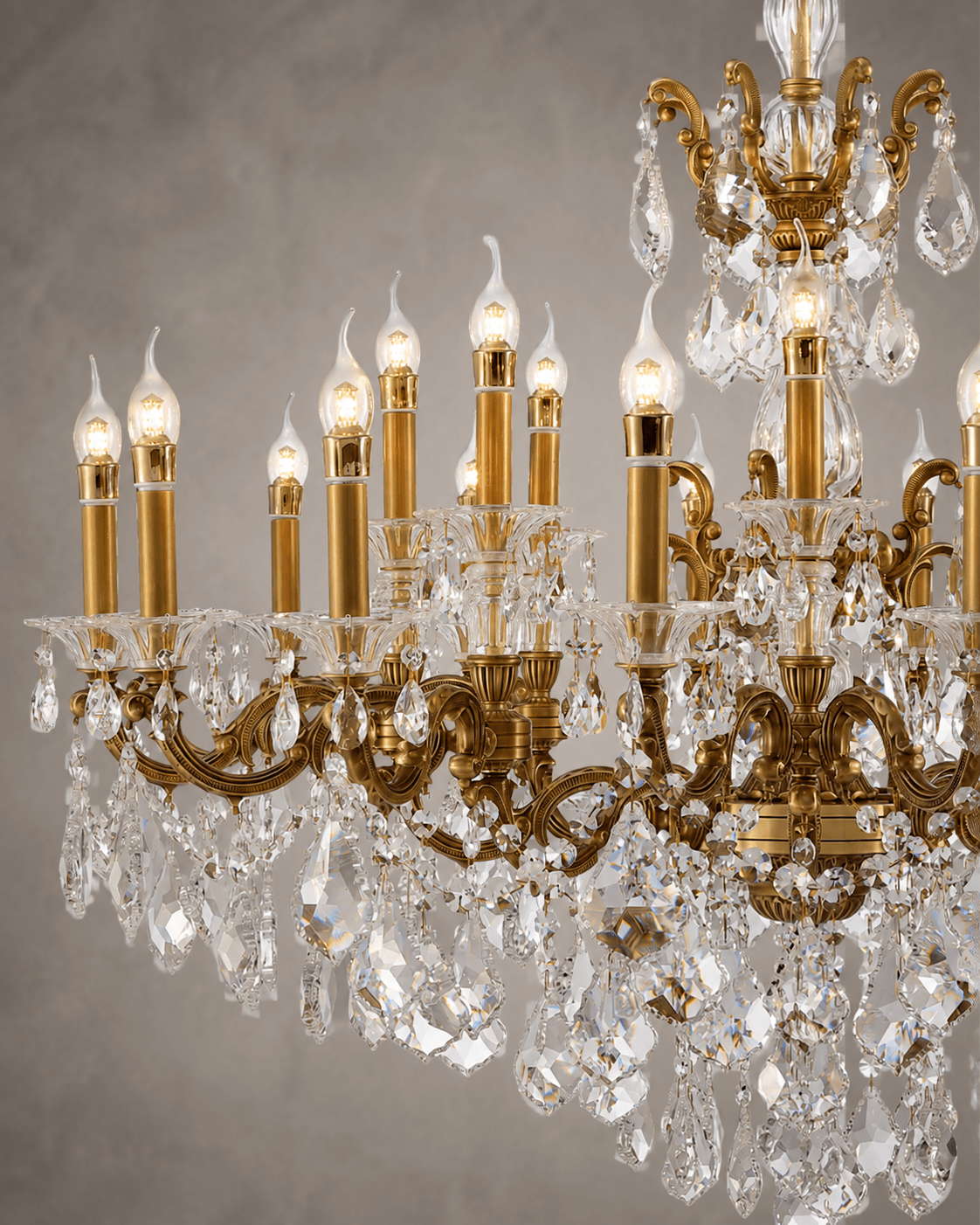 Close-up of Imperial Grace Regina crystal chandelier with bronze-gold arms and illuminated candle bulbs.
