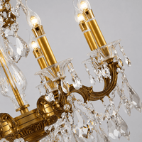 Close-up of Shine chandelier showing bronze candle arms and Asfour crystal drops.