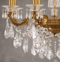 Close-up of Imperial Grace Shine chandelier by HDLS Lighting showing bronze arms and Asfour crystal drops.