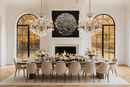 Two Shine chandeliers installed in a grand dining room with tall arched windows.