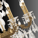 Close-up of Shine chandelier showing bronze candle arms and Asfour crystal drops.