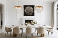 Pair of La Scala Crystal Contessa chandeliers illuminating luxury dining room with gold elegance.