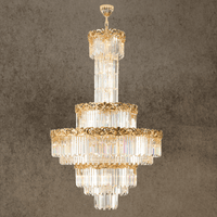 La Scala Crystal Sovrano chandelier with 18K gold-plated copper and crystal tiers on grey background.