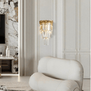 La Scala Crystal Visconte wall light styled in a modern marble-wall interior, radiating soft gold and crystal illumination.
