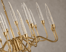 Close-up of Luce di Roma Theia luxury gold chandelier with champagne crystal candle lights and sculptural arms