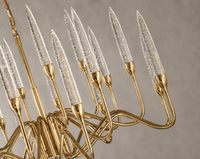 Close-up of Luce di Roma Theia luxury gold chandelier with champagne crystal candle lights and sculptural arms