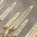 Close-up of Luce di Roma Theia champagne crystal candle lights with 18K gold-plated luxury chandelier details