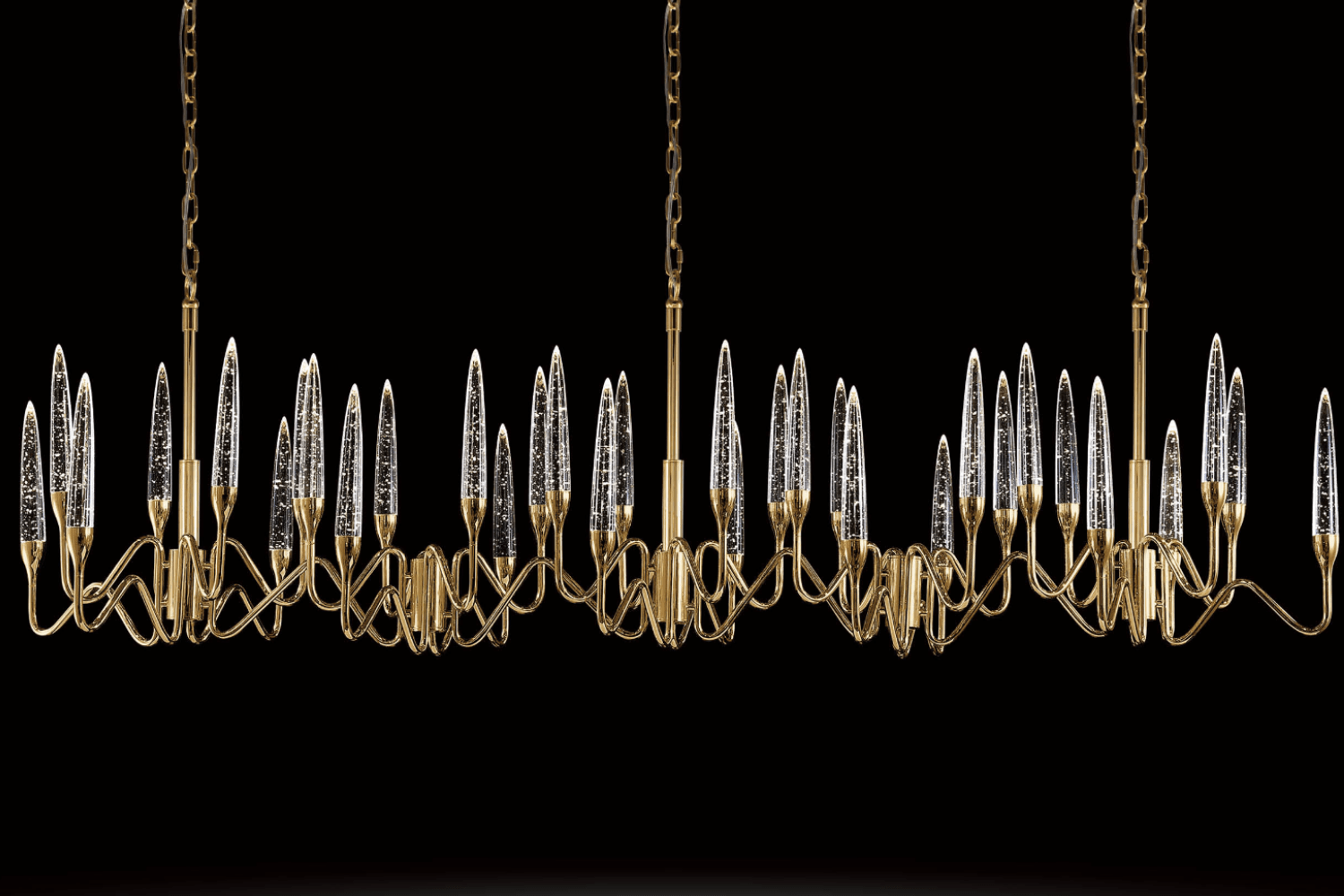 Luce di Roma Vesta chandelier glowing against a black background, highlighting gold framework and champagne crystal.