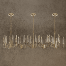 Luxury Luce di Roma Vesta linear chandelier with 18K gold-plated frame and Asfour crystal spires on a stone background.