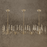 Luxury Luce di Roma Vesta linear chandelier with 18K gold-plated frame and Asfour crystal spires on a stone background.