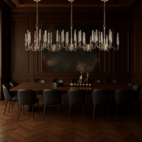 Luce di Roma Vesta chandelier above a luxury dining table, featuring gold frame and champagne crystal spires.