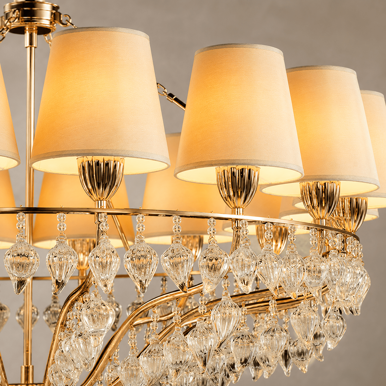 Close-up of Luce Regale Avorio Classica chandelier with ivory shades, gold frame and glass drops
