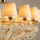 Close-up of Luce Regale Avorio Classica chandelier with ivory shades, gold frame and glass drops