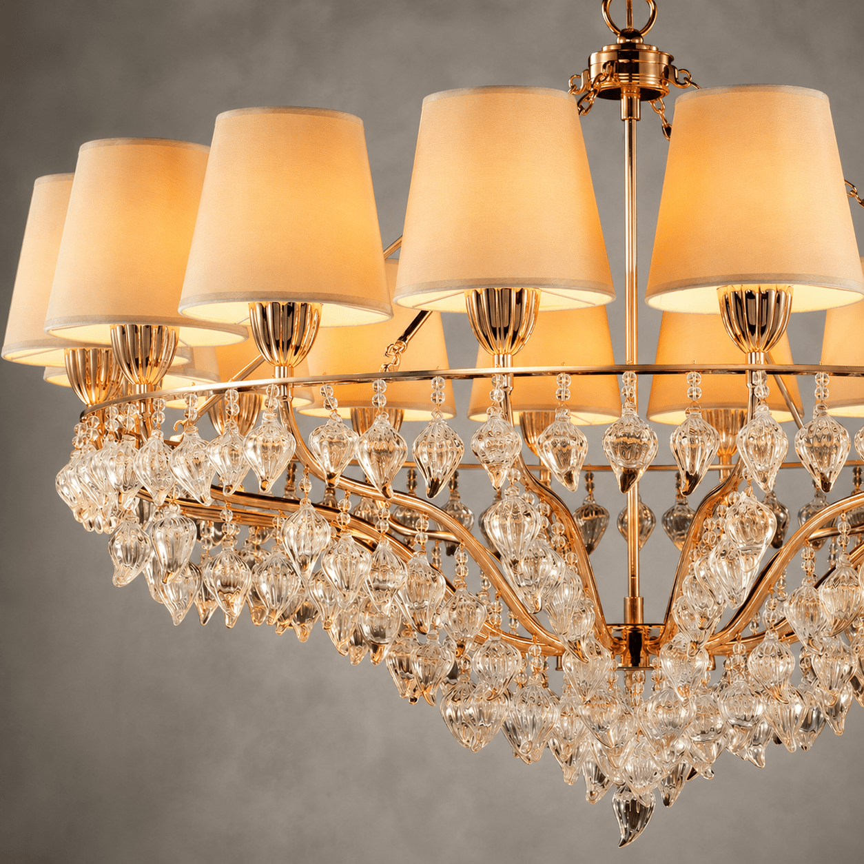 Close-up of Luce Regale Avorio Grande chandelier with ivory shades, gold frame and clear crystal drops