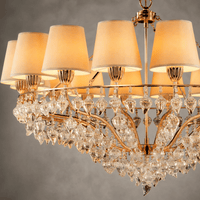 Close-up of Luce Regale Avorio Grande chandelier with ivory shades, gold frame and clear crystal drops