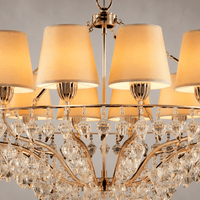 Close-up of Luce Regale Avorio Magnifica chandelier with ivory shades and sculpted glass drops