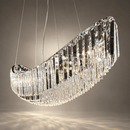 Close-up of Lucerne Arc chandelier showing layered A+ lead-free crystal prisms along its sweeping stainless steel frame.