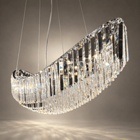 Close-up of Lucerne Arc chandelier showing layered A+ lead-free crystal prisms along its sweeping stainless steel frame.