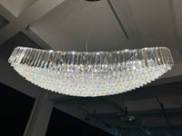 Installed 220 cm Lucerne Arc crystal chandelier illuminated, revealing its sweeping curved profile and layered prisms.