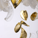 Close-up of hand-forged Murano-style magnolia glass petals with gold details.