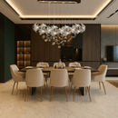 Magnolia Grazia floral chandelier lighting a modern dining room, highlighting gold accents and Murano-style magnolia flowers.