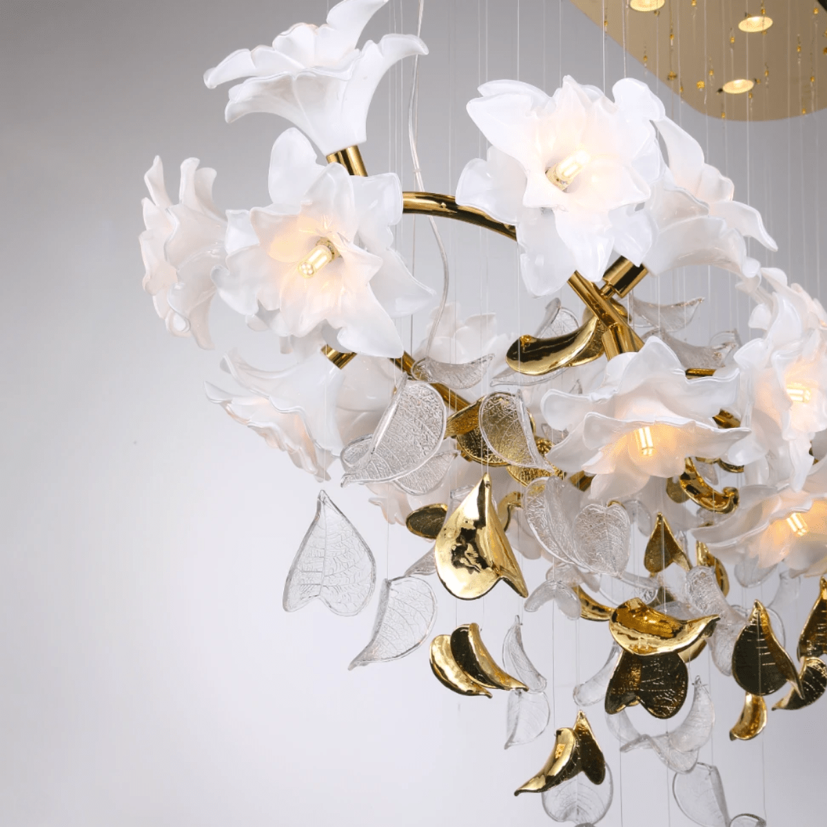 Detail of sculpted magnolia glass petals and gold leaf accents, emphasizing the chandelier’s Murano-style artistry.