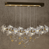 Murano-style glass magnolia linear chandelier in gold finish, with sculpted floral design and a rectangular ceiling plate.