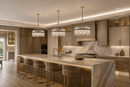 Three Manhattan Orbit Crystal Chandeliers above a marble kitchen island in a luxury Texas residence.