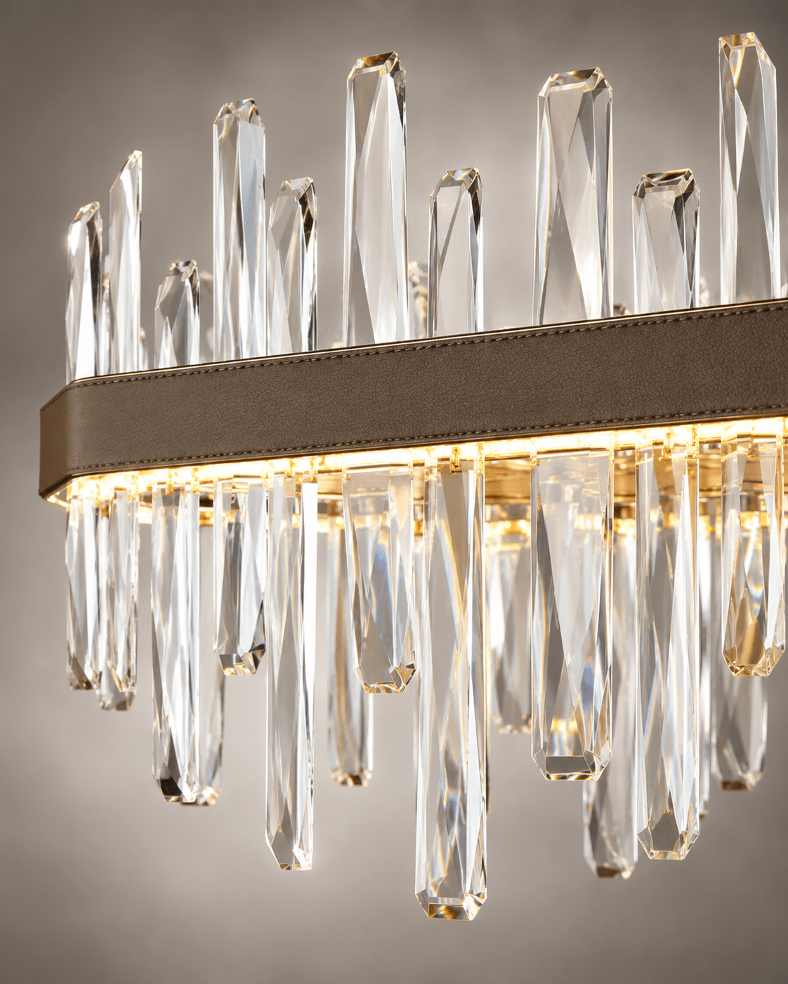 Close-up of Manhattan Square Crystal Chandelier with clear faceted crystals and leather-wrapped gold frame.