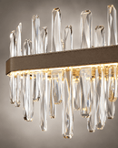 Close-up of Manhattan Square Crystal Chandelier with clear faceted crystals and leather-wrapped gold frame.