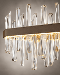 Close-up of Manhattan Square Crystal Chandelier with clear faceted crystals and leather-wrapped gold frame.