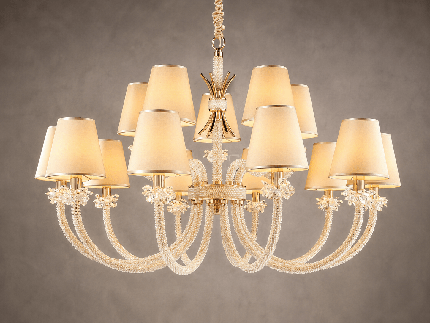 Close up of the Maria Grandeur 15-light chandelier with ivory shades and crystal-wrapped arms shown on a light grey background.