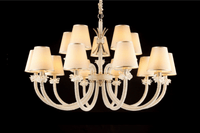 Hero image of the Maria Grandeur 15-light chandelier with ivory shades and crystal-wrapped arms shown on a black background.