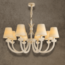 Maria Luxe 8-light gold crystal chandelier with ivory shades and Asfour crystal arms, shown against a grey wall background.