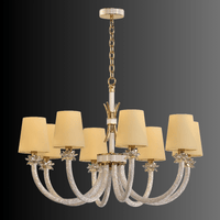 Maria Luxe chandelier on a dark gradient background, featuring 8 ivory shades, crystal-wrapped arms, gold detailing.