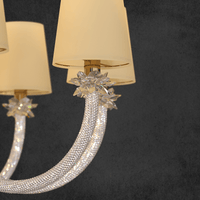 Close-up of Maria Luxe chandelier showing precision-cut Asfour crystal flowers and crystal-wrapped gold arm detailing.