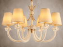 Close up shot of the Maria Petite Eclat showing the crystal, gold and fabric details against a light grey background.