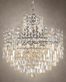 Close-up of Maurice Argent chrome crystal chandelier with tiered prisms and polished metal frame.