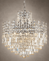 Close-up of Maurice Argent chrome crystal chandelier with tiered prisms and polished metal frame.