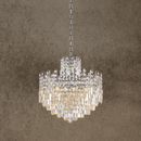 Maurice Argent crystal chandelier with stainless steel and Asfour crystals on a warm front view against a  beige backdrop.
