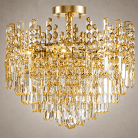 Close-up of Maurice Doré gold semi-flush chandelier with layered Asfour crystal prisms.