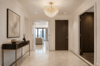 Maurice Doré gold crystal semi-flush chandelier installed in a luxury Chelsea apartment entrance.