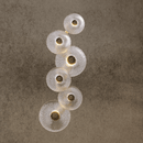 Hand-forged Murano-style glass Modernus Amoria wall lamp on beige wall, glowing with warm integrated LED light.
