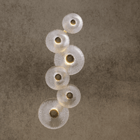 Hand-forged Murano-style glass Modernus Amoria wall lamp on beige wall, glowing with warm integrated LED light.