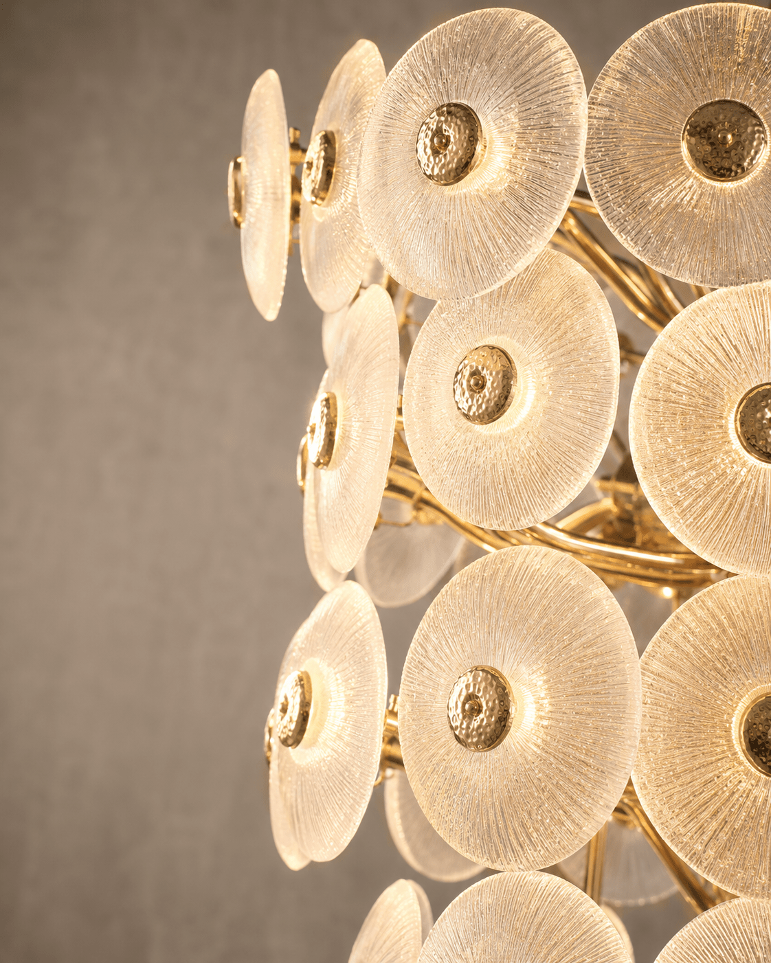 Close up shot of glass and gold parts of the Modernus Grande large glass chandelier.
