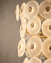 Close up shot of glass and gold parts of the Modernus Grande large glass chandelier.